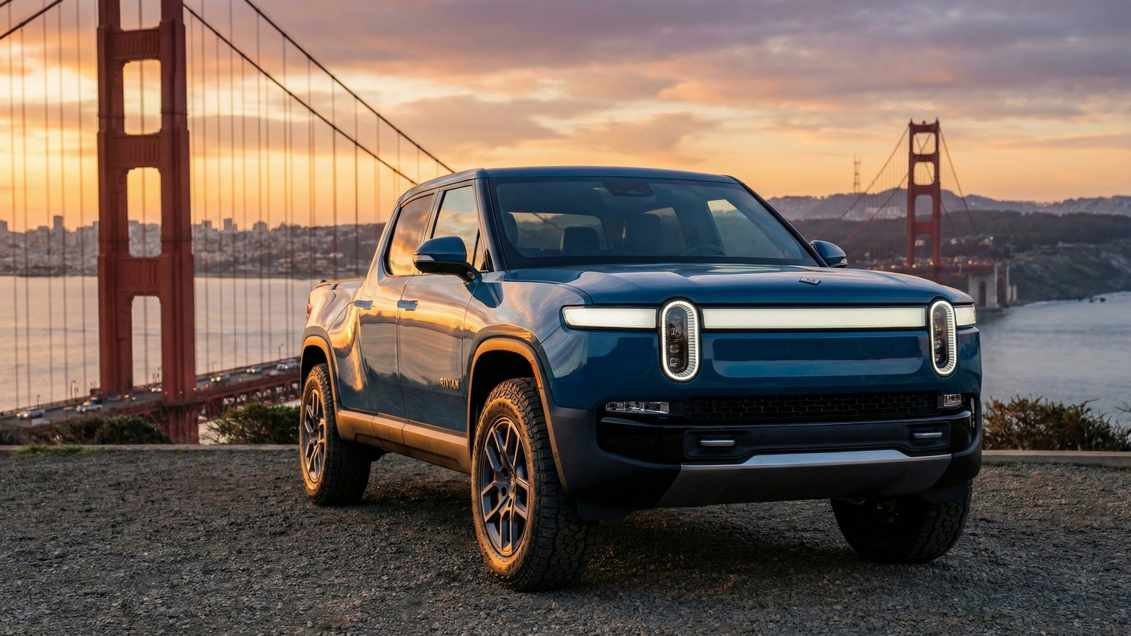 Sell Your Rivian R1T in San Francisco Blue Rivian R1T electric pickup parked near the Golden Gate Bridge at sunset, illustrating an option for California owners looking to sell their truck.