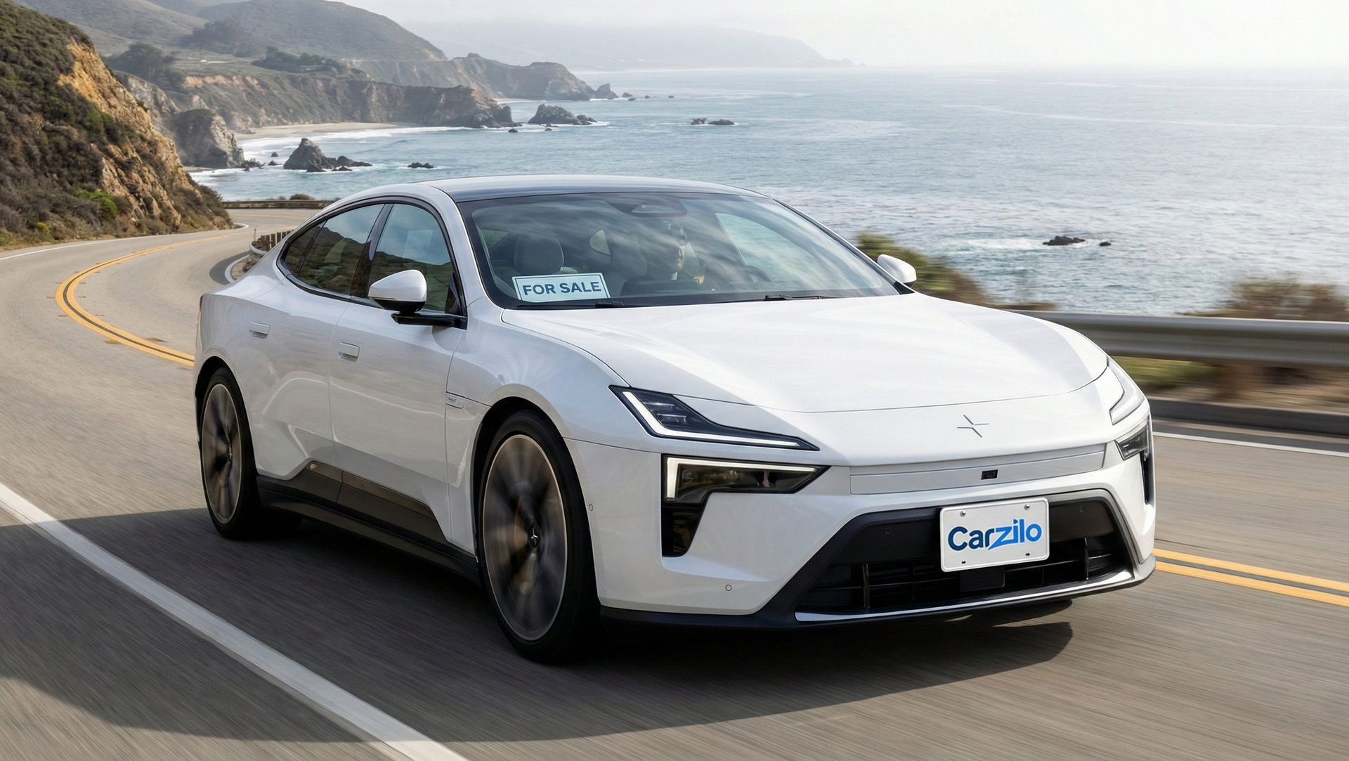 Sell Your Polestar 4 Fast in California Polestar 4 white fastback driving along a coastal California highway with a for sale sign in the windshield.