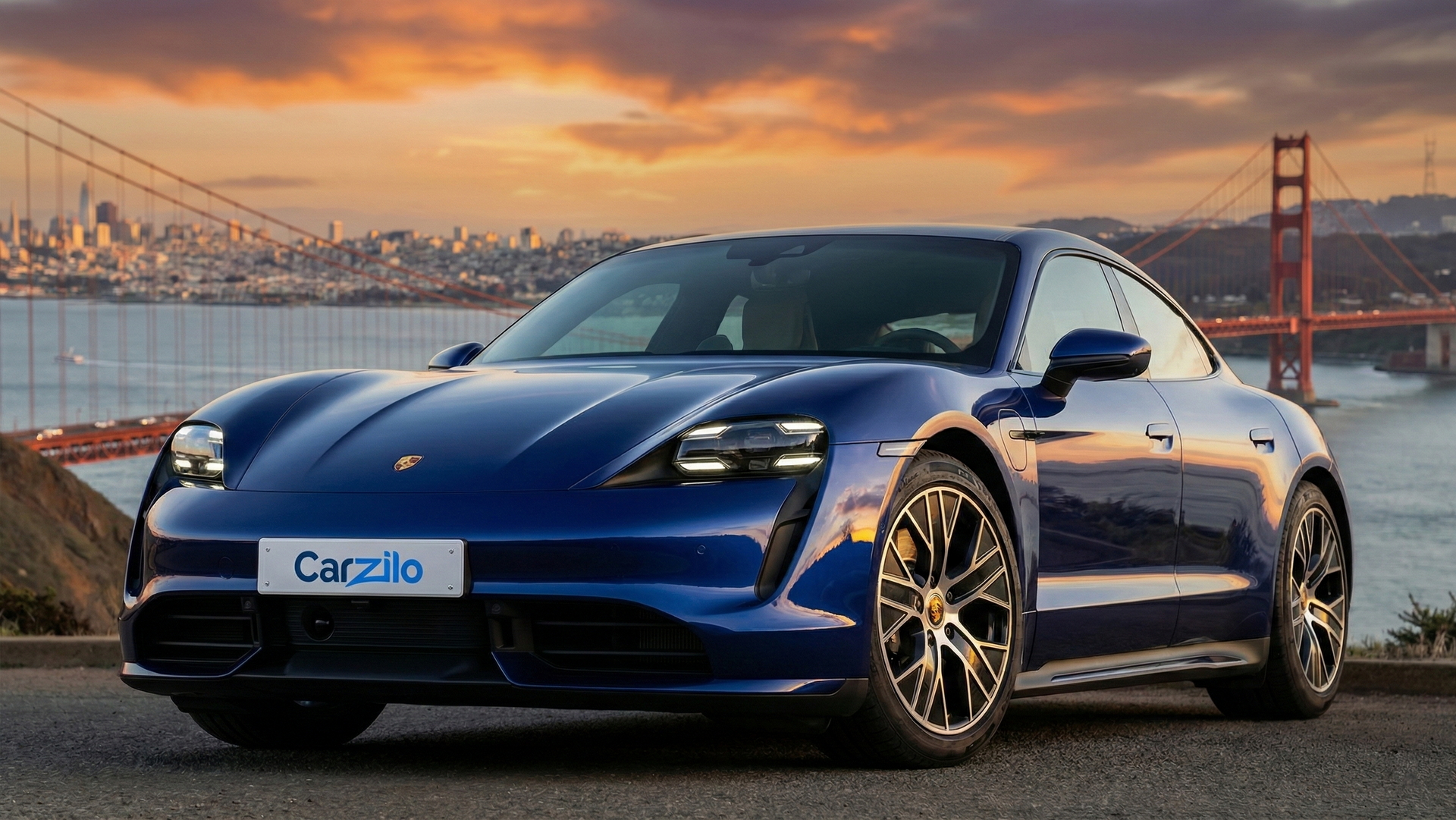 Porsche Taycan blue electric sedan parked near the Golden Gate Bridge at sunset, ideal for California owners getting ready to sell their car.